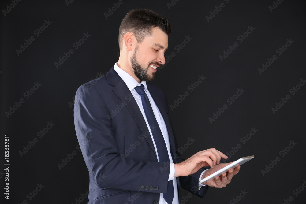 Stock exchange broker with tablet on dark background Stock exchange broker with tablet on dark background