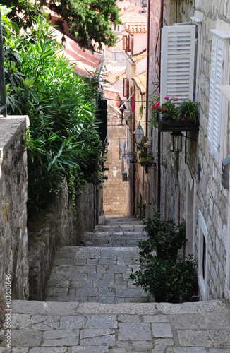 old narrow street in Europe, lined with pavers, houses with facades in Croatia or Italy