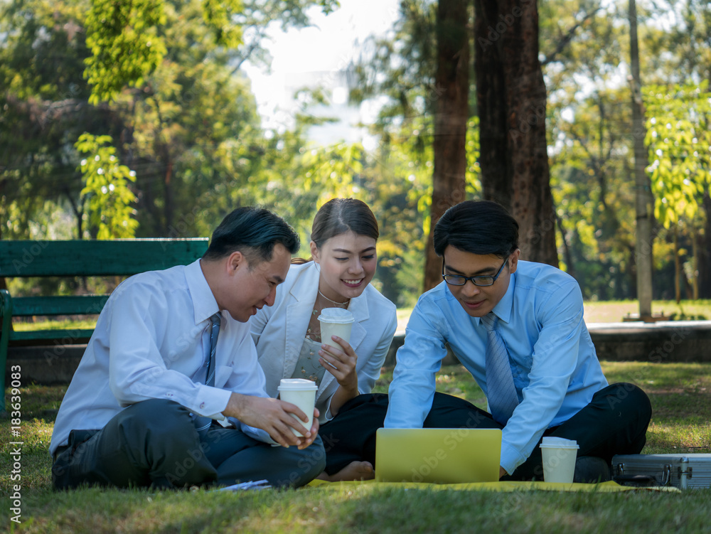 Business people having a business conversation in the park Business people having a business conversation in the park