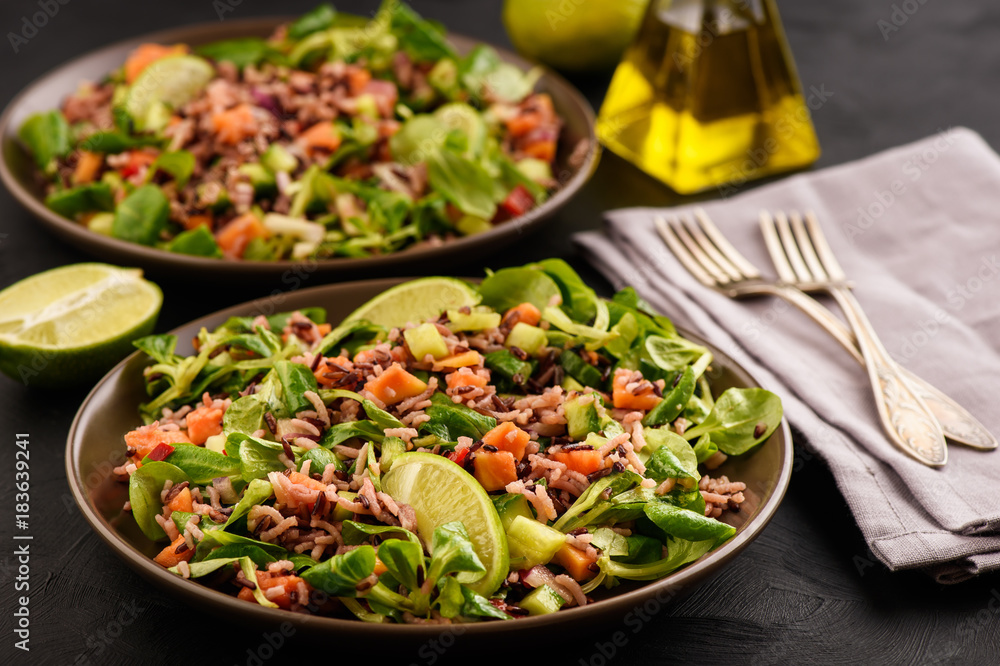 Salad with wild rice, papaya, lime and cucumber. Salad with wild rice, papaya, lime and cucumber.