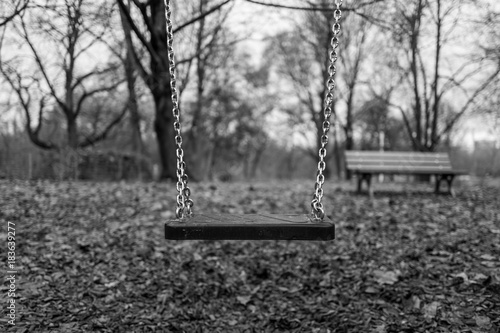 Empty swing on playground photo