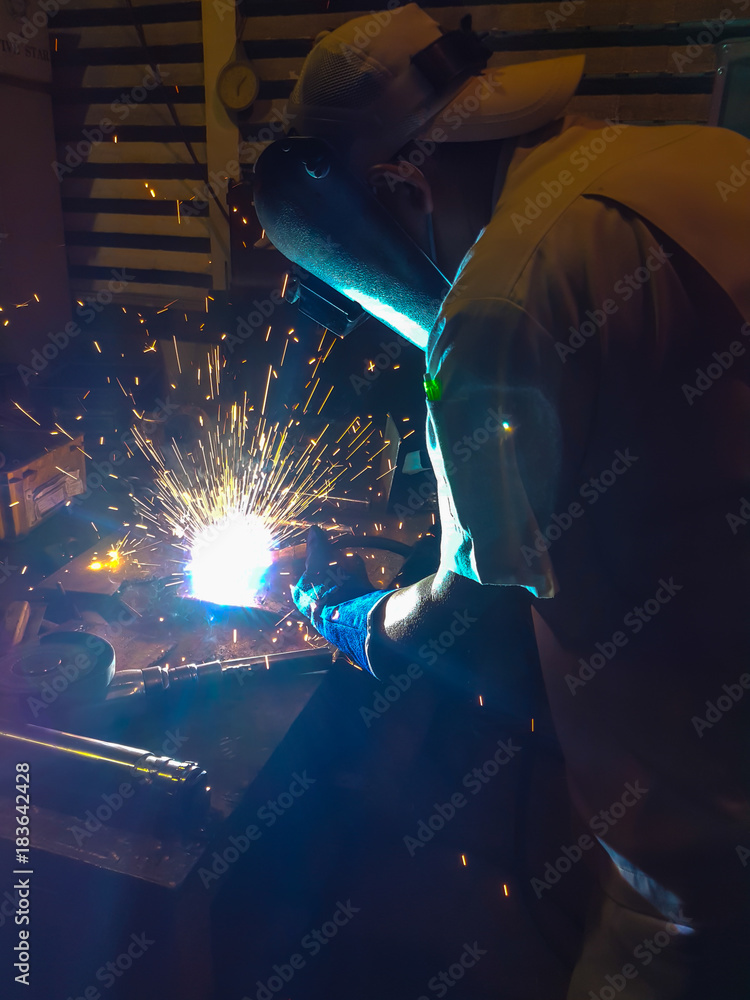 Worker, welding steel in factory manufacturing industry
Worker, welding steel in factory manufacturing industry