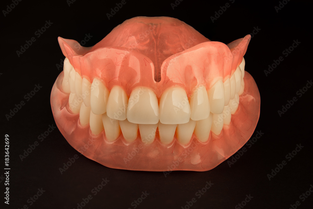 acrylic human dentures with dollars and money icons on white plastic teeth with flare on white isolated background acrylic human dentures with dollars and money icons on white plastic teeth with flare on white isolated background