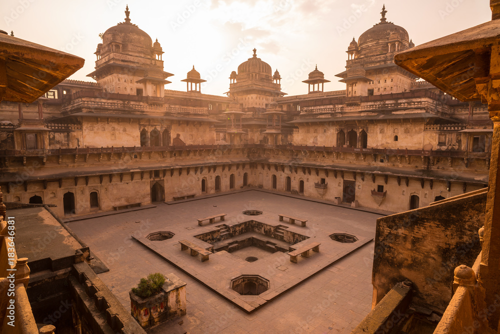 Orchha Palace, interior with courtyard and stone carvings, backlight. Also spelled Orcha, famous travel destination in Madhya Pradesh, India.