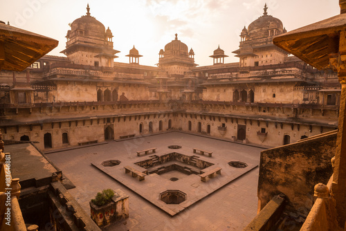 Orchha Palace, interior with courtyard and stone carvings, backlight. Also spelled Orcha, famous travel destination in Madhya Pradesh, India. photo