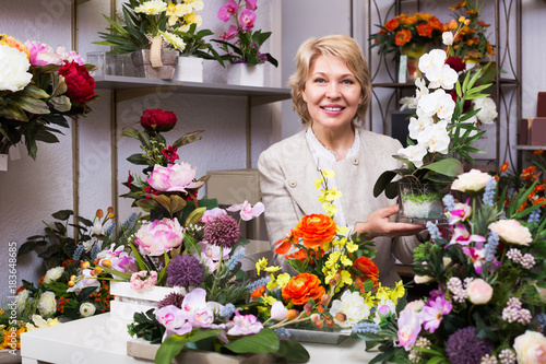 Woman selecting flowers in store
