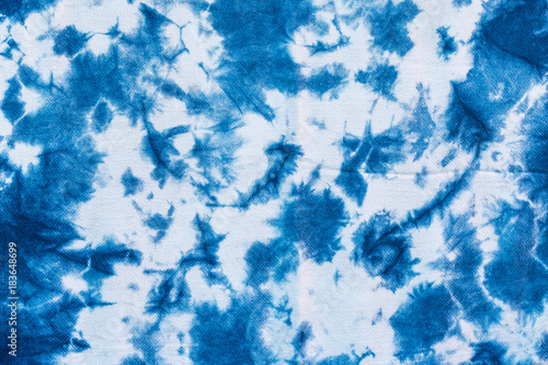 The fabric indigo tie dye as a background and texture. photo