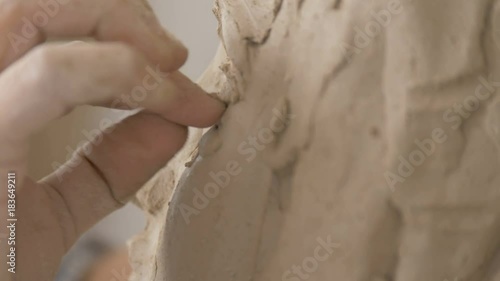 A sculptor creates a sculpture.