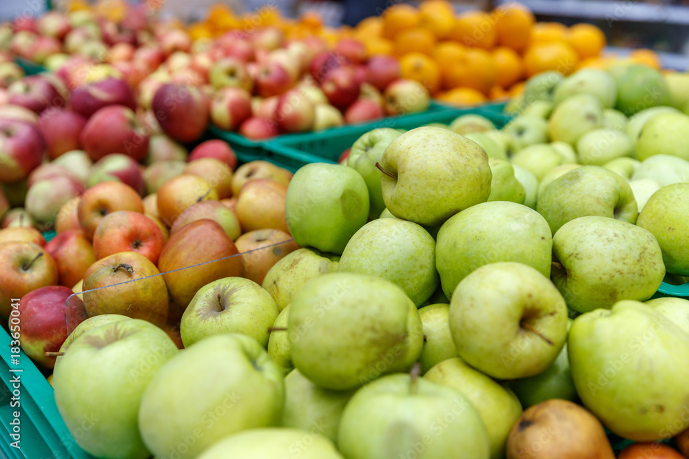 apples of different colors on display in a market apples of different colors on display in a market