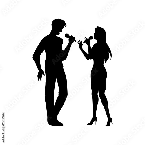 Full length portrait, figures of man and woman singing with microphones, black vector silhouette isolated on white background. Black silhouettes of man and woman singing together