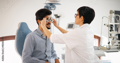 Woman doing eye test with optometrist in eye sight clinic