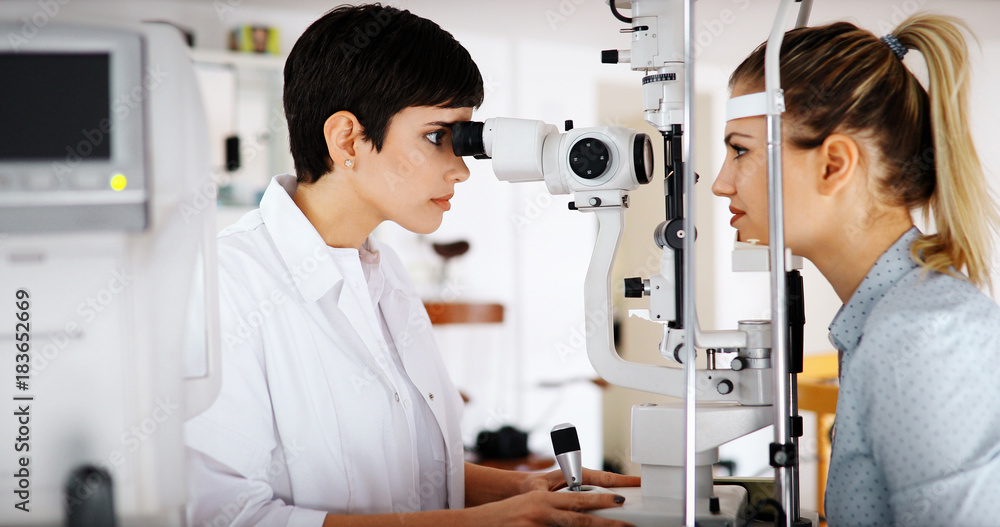 optometrist checking patient eyesight and vision correction optometrist checking patient eyesight and vision correction