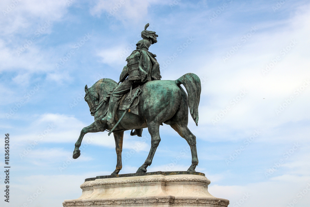 statue with blue sky at Piazza Venezia in rome