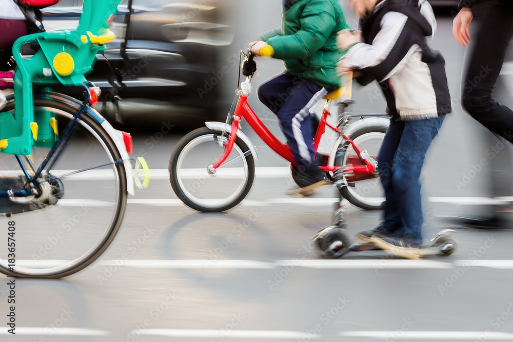 children with bicycles crossing a street children with bicycles crossing a street