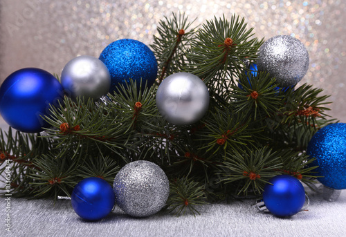 Decorative background with fir branches and balls on the silver. Christmas card Holiday Concept