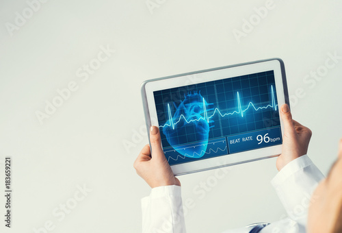 Close of female doctor hands working with tablet pc computer