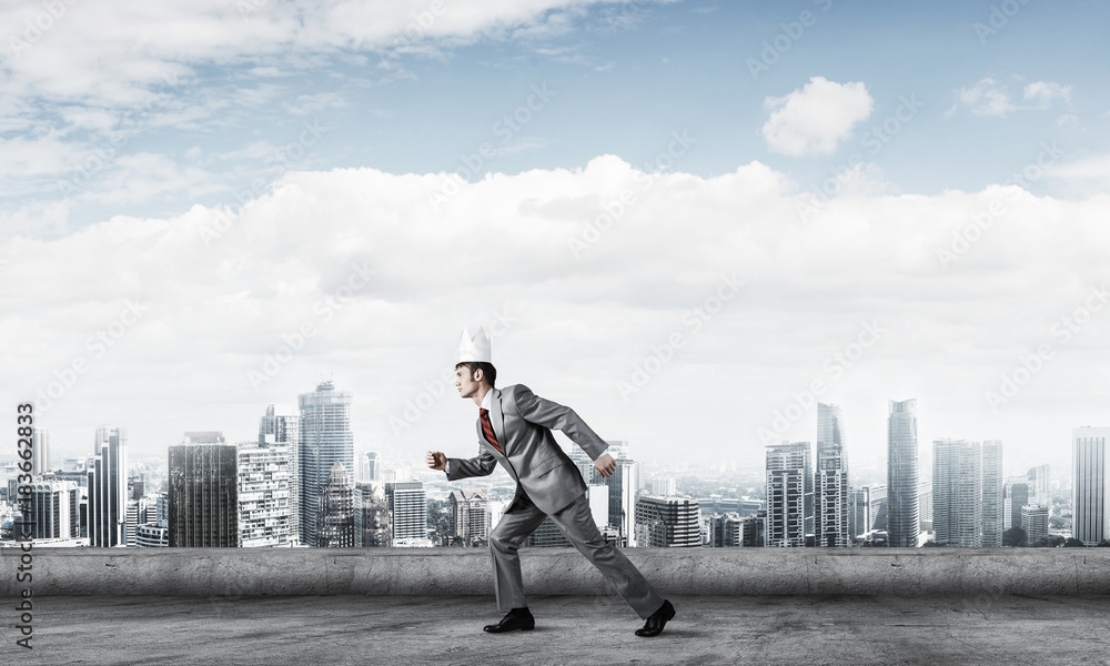 King businessman in elegant suit running on building roof and bu King businessman in elegant suit running on building roof and bu