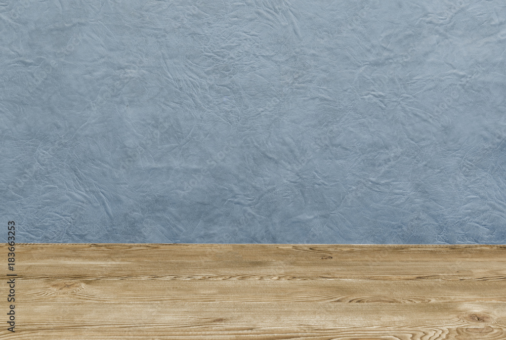 Empty wooden deck table over blue painted wall Empty wooden deck table over blue painted wall