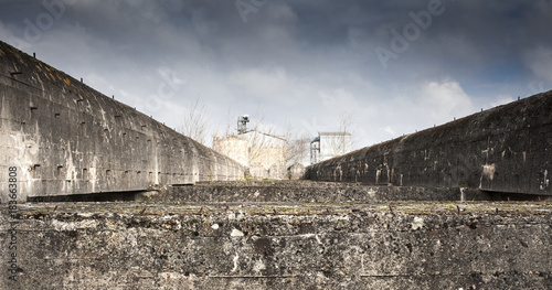 Strong topwith  straight concrete walls of a submarine bunker in St Nazarre, France photo