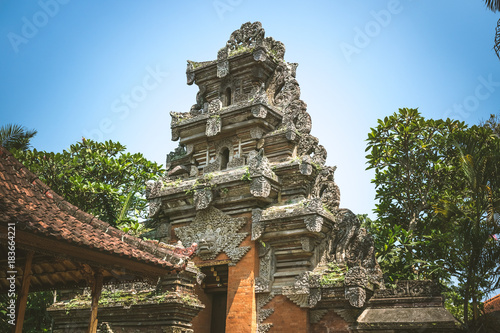 traditional tower with reliefs of stone in a temple arquitecure balinese. ubud. bali photo