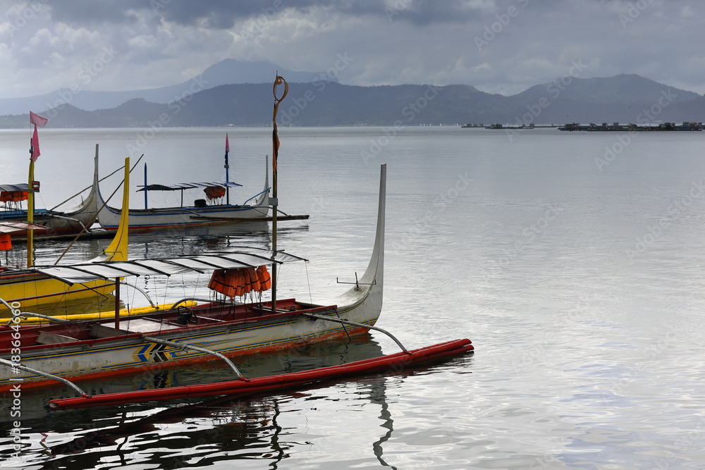 Pump boats in Taal lake under menacing sky. Talisay-Batangas-Luzon-Philippines. 0007