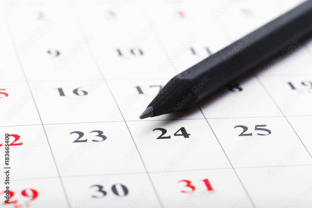 Check out the dates in a business calendar concept Check out the dates in a business calendar concept