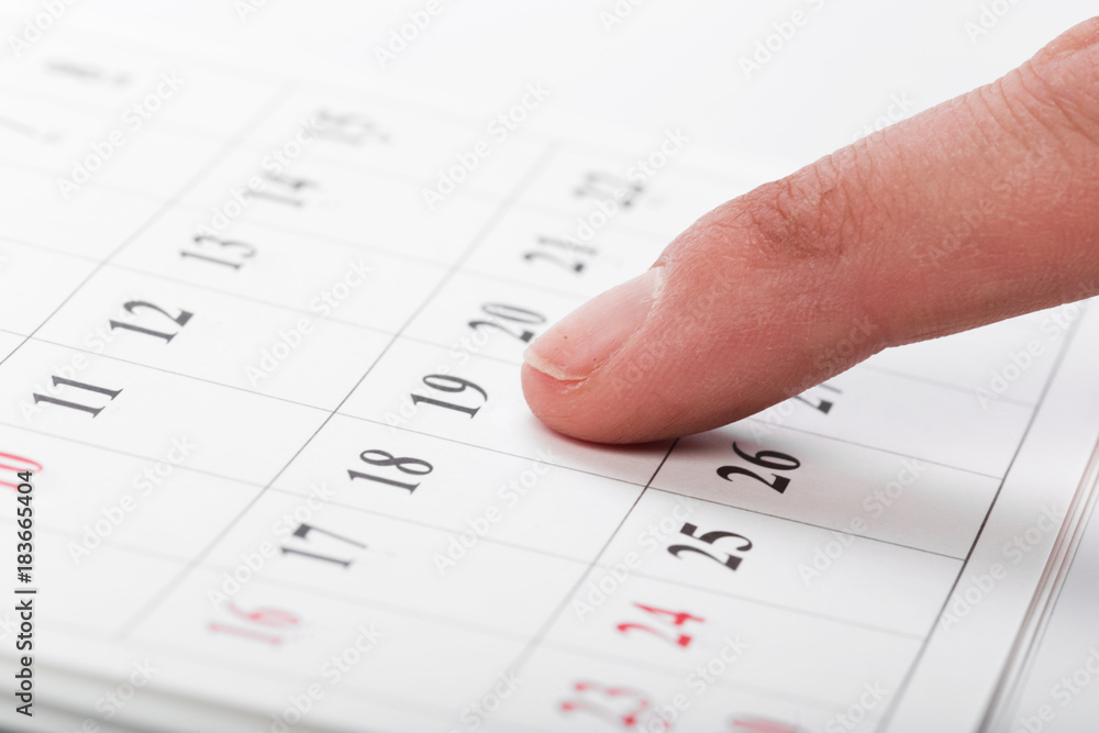 Check out the dates in a business calendar concept Check out the dates in a business calendar concept