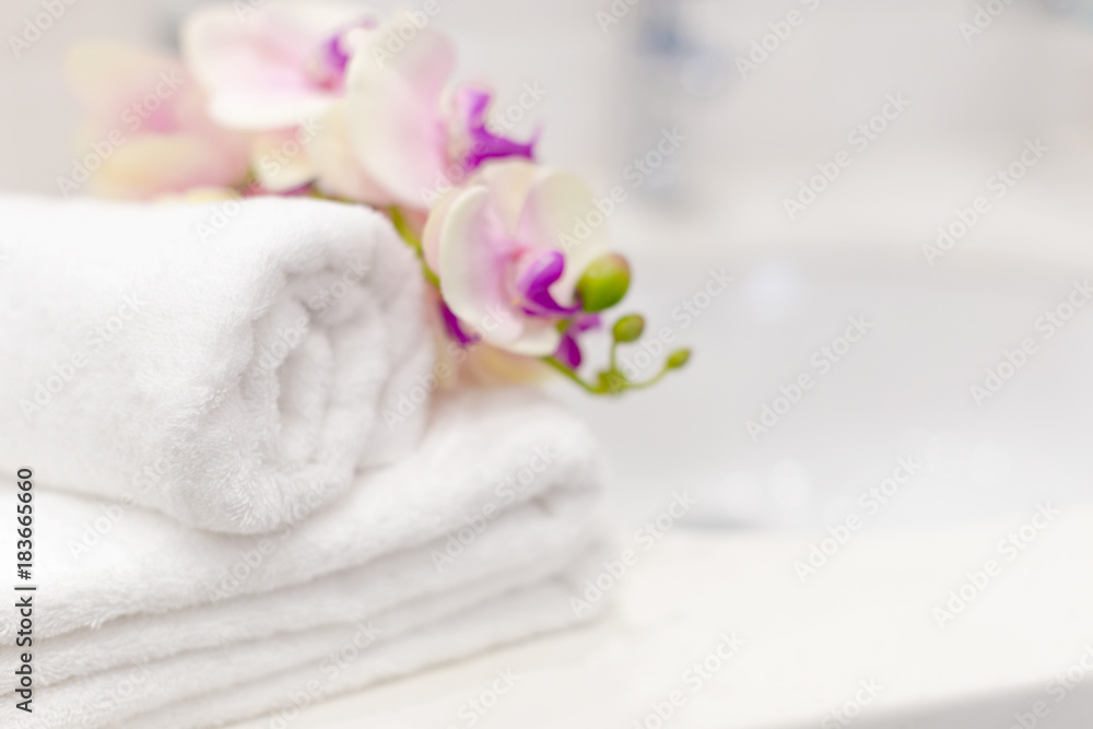 Stack of towels with flower decor in a hotel room Stack of towels with flower decor in a hotel room