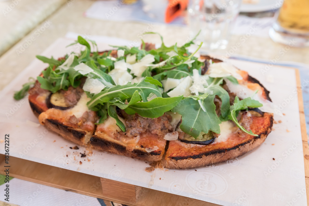 Bruschetta with meat, cheese and rocket