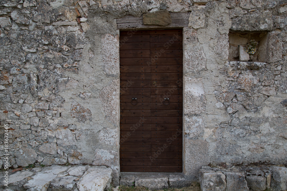 Entrance of an antique stone house in Italy 