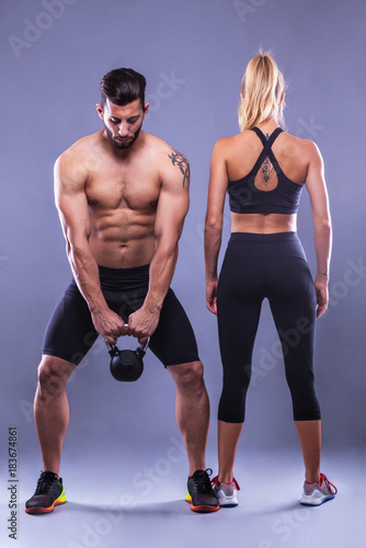 fitness woman and man on a gray background