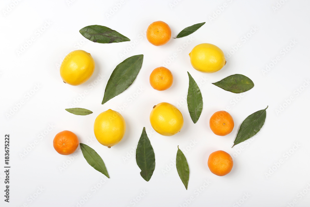 tangerines and lemons with leaves on a white background. tangerines and lemons with leaves on a white background.