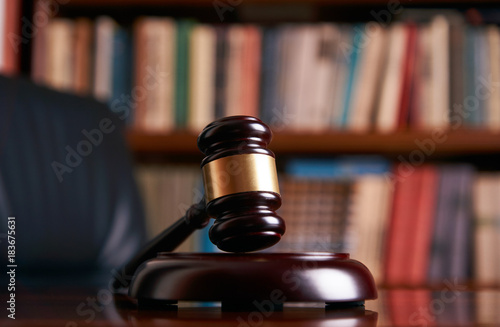 Judge gavel on wooden table in library