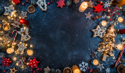 Christmas background with wooden decorations and candles. Free space for text.
