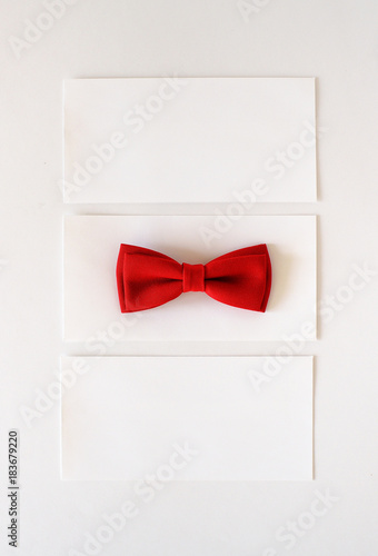 white gift envelope with a red bow on a white background
