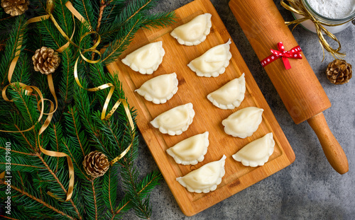 Christmas dumplings with decoration on a wooden board. Top view. photo