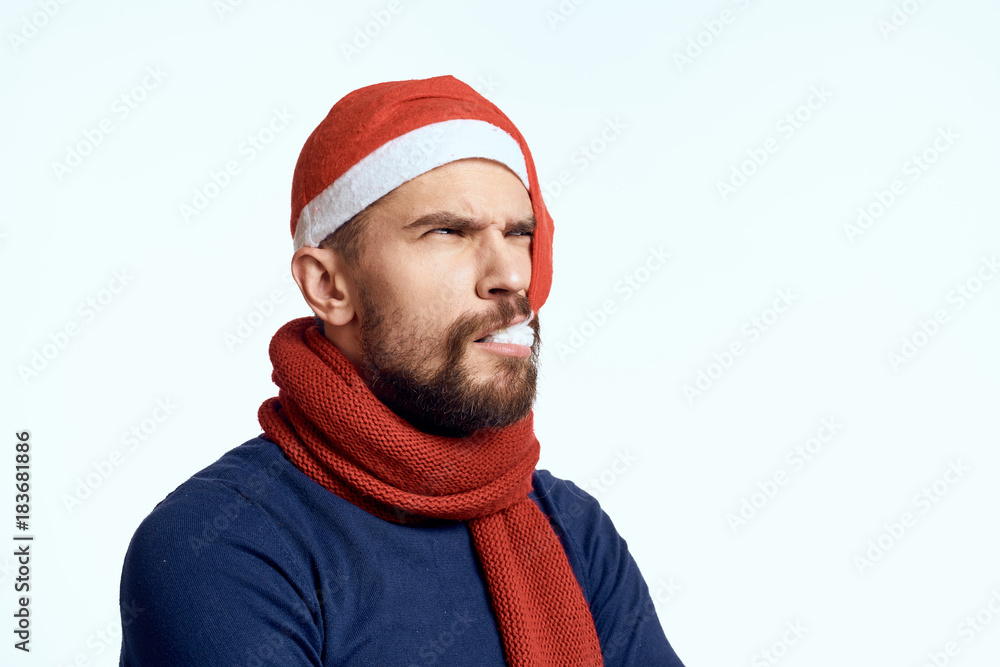 man holds in the mouth the tip of his New Year's cap, scarf, new year man holds in the mouth the tip of his New Year's cap, scarf, new year