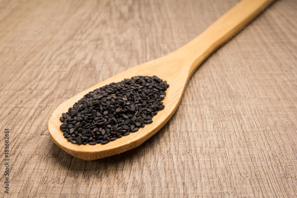 Benniseed. Spoon and grains over wooden table. Benniseed. Spoon and grains over wooden table.