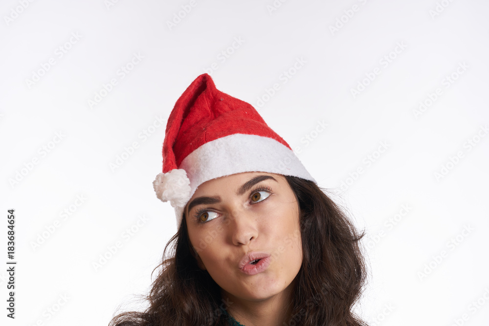 portrait of a woman in a Christmas hat, light background, new year