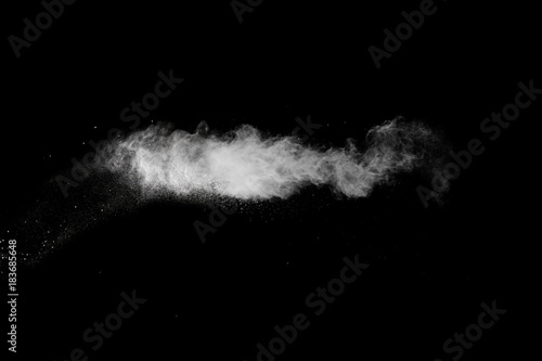 Abstract white powder splatter on black background,Freeze motion of color powder explosion. Splash of powder dust on black background.