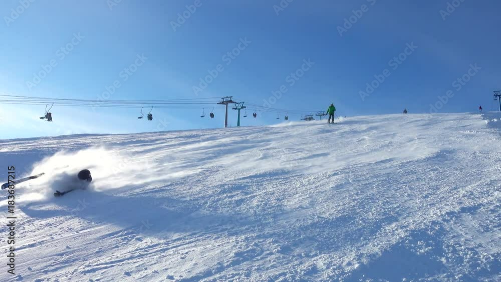 Skiers Skiing Down The Slope and falling at competition in sunny day Skiers Skiing Down The Slope and falling at competition in sunny day