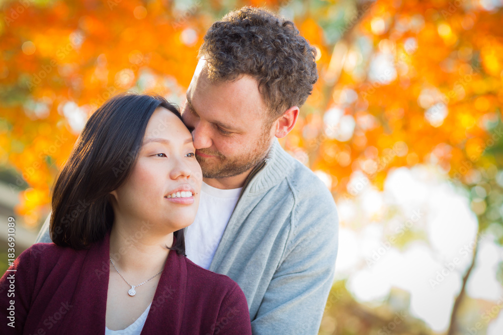 Outdoor Fall Portrait of Chinese and Caucasian Young Adult Couple. Outdoor Fall Portrait of Chinese and Caucasian Young Adult Couple.