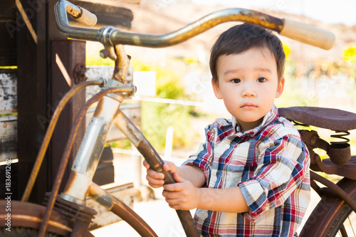 Mixed Race Caucasian and Chinese Young Boy Having Fun on the Bicycle.