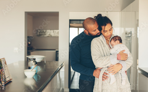 Parents spending time with newborn son in morning