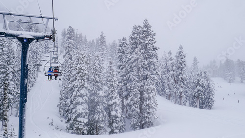 16x9, wide screen. Lift system at ski resort in California, Mammoth mountain. Fir trees covered by white snow - aerial view. Breathtaking winter scenes