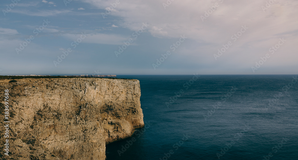 Cliff into the ocean. São Vicente cape, Sagres, Algarve, Portugal.