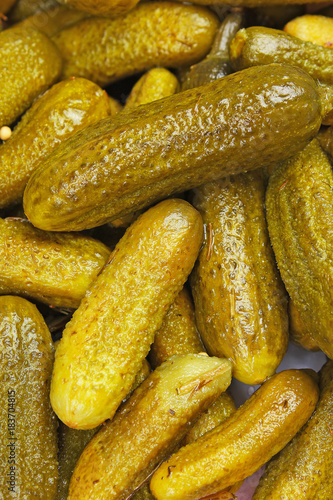Pickles as background. Green pickle texture pattern. Pickled cucumber background. Texture closeup pattern. Vegetable.
