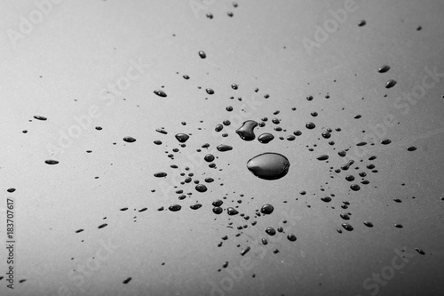 Liquid or water drops splash on the black floor ,abstract background
