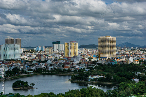 Landscape view from the top, lake, hills, buildings and cloudy sky. Vung Tau, Vietnam.