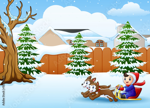 Cartoon boy riding sled on the snowing village pulled by two dogs